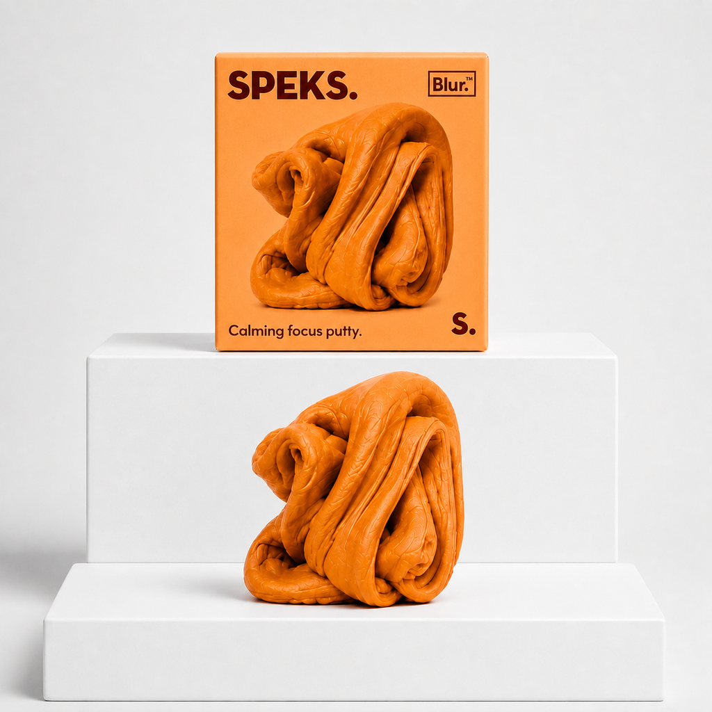 Clementine orange Speks Blur Focus Putty with matching box on a neutral white studio background