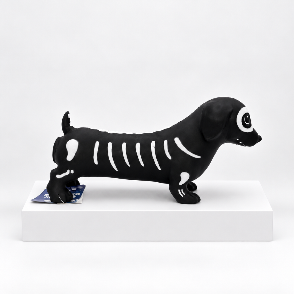 Black dachshund-shaped toy with white skeleton pattern, side view
