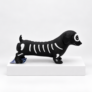 Black dachshund-shaped toy with white skeleton pattern, side view