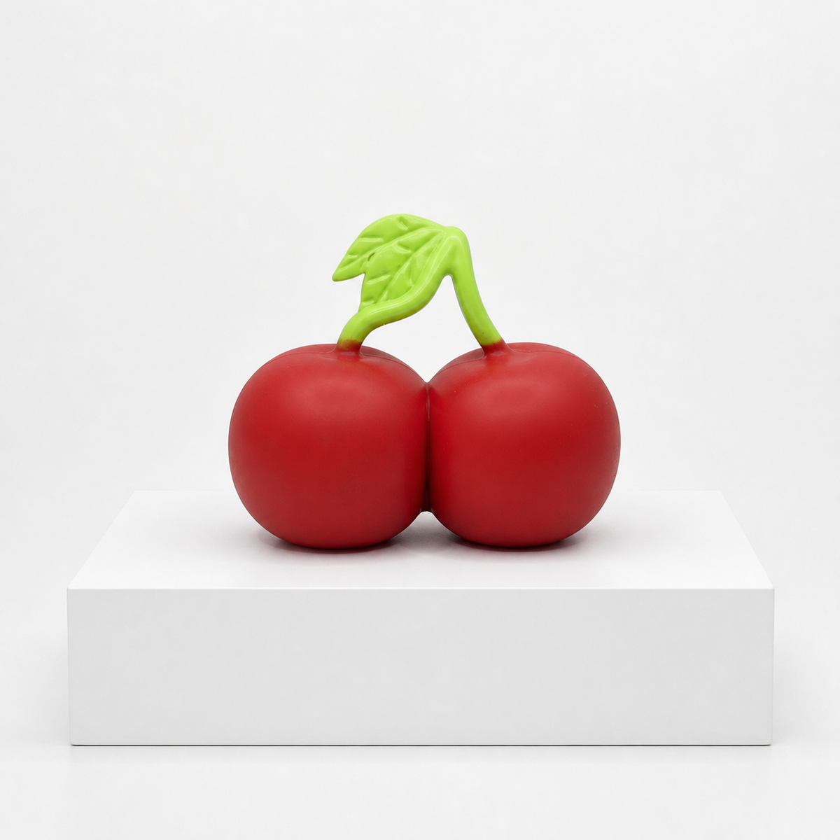 Loose Sunny Days Entertainment Squeeezy Cherries sensory fidget toy on a white display slab