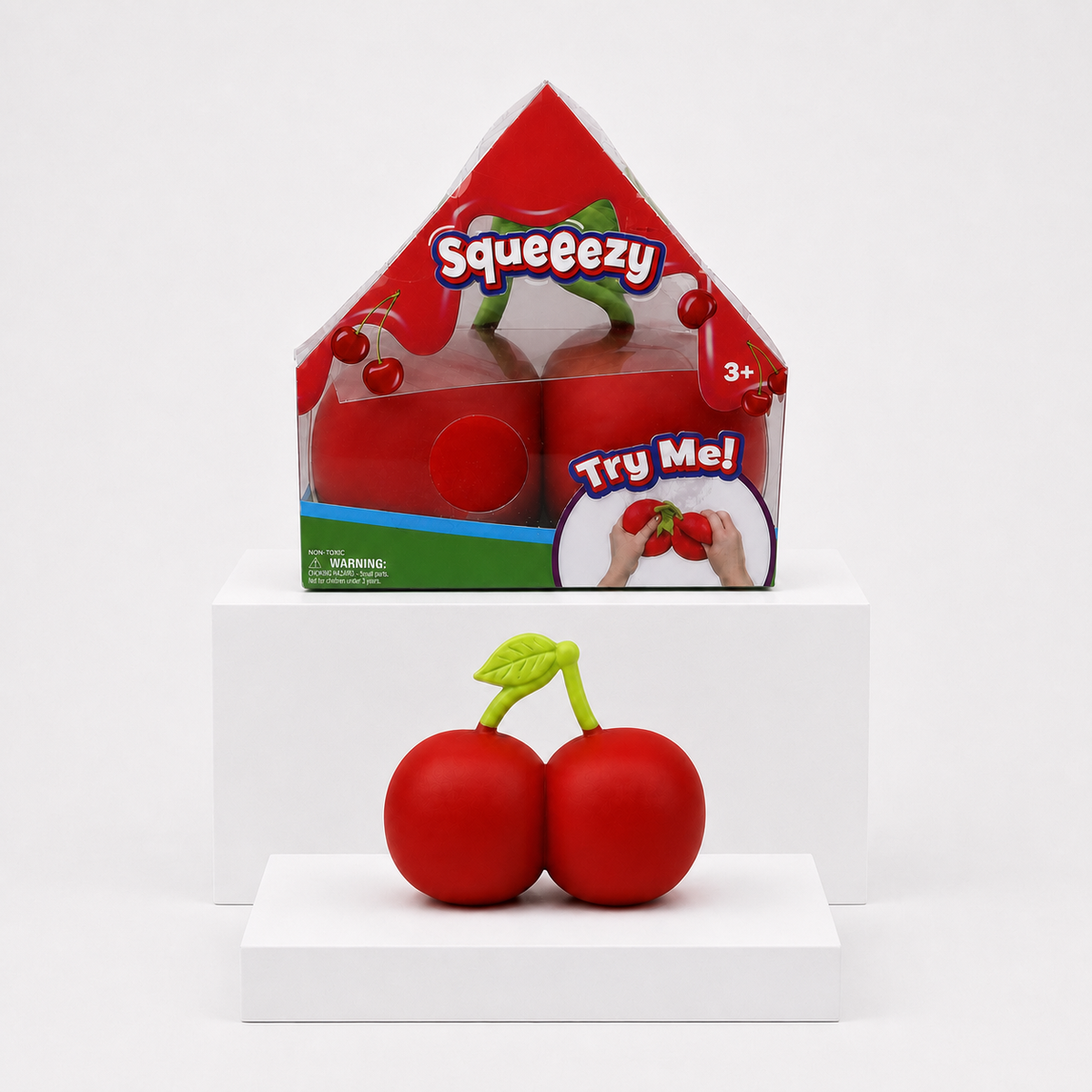 Sunny Days Entertainment Squeeezy Cherries package and loose sensory fidget toy on white display slabs