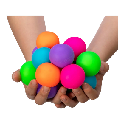 Squish Planet Teenie NeeDoh Groovy Glob sensory toys in neon orange, purple, teal, pink, and green held in hands.