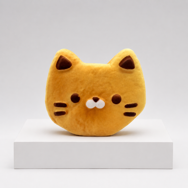 Cat-shaped animal bread squish toy with pointed ears, whiskers and white muzzle on a white podium