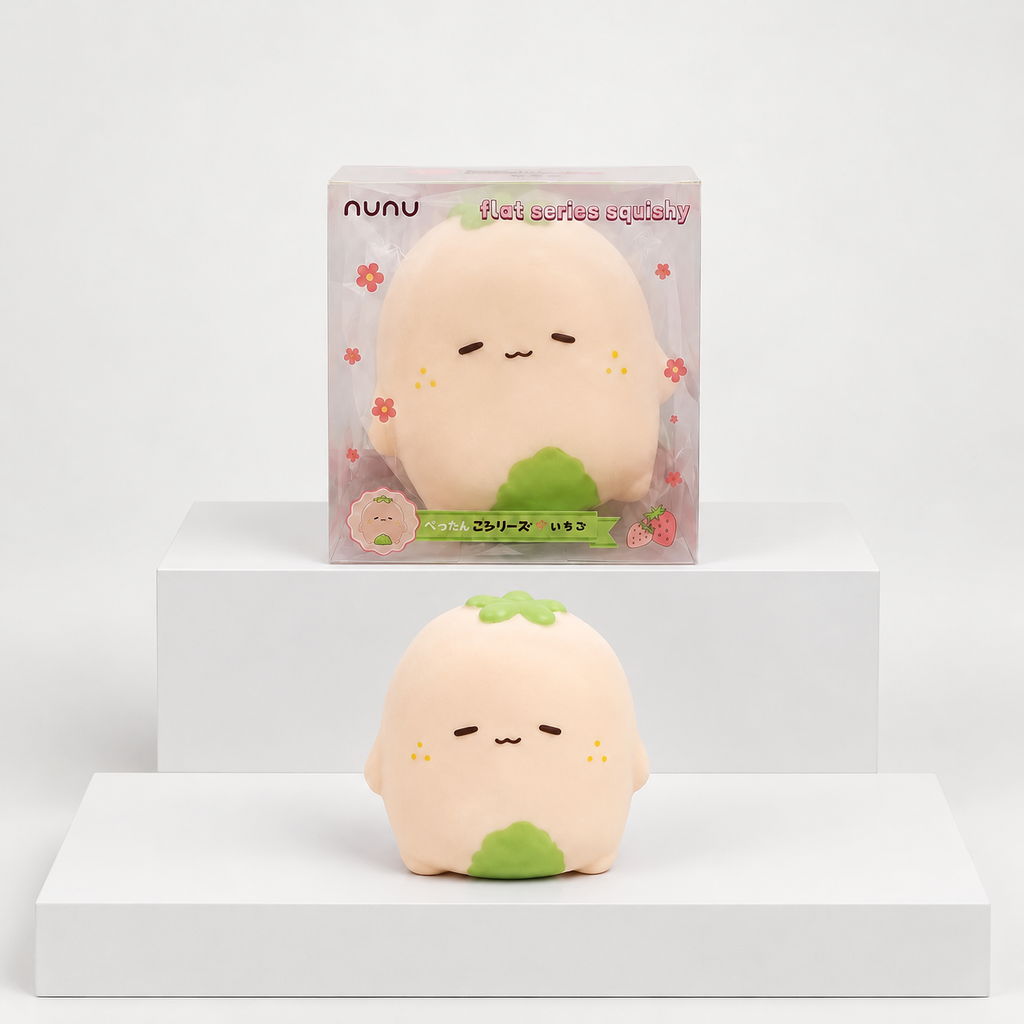 Pale pink Nunu strawberry character with green details displayed beneath its box