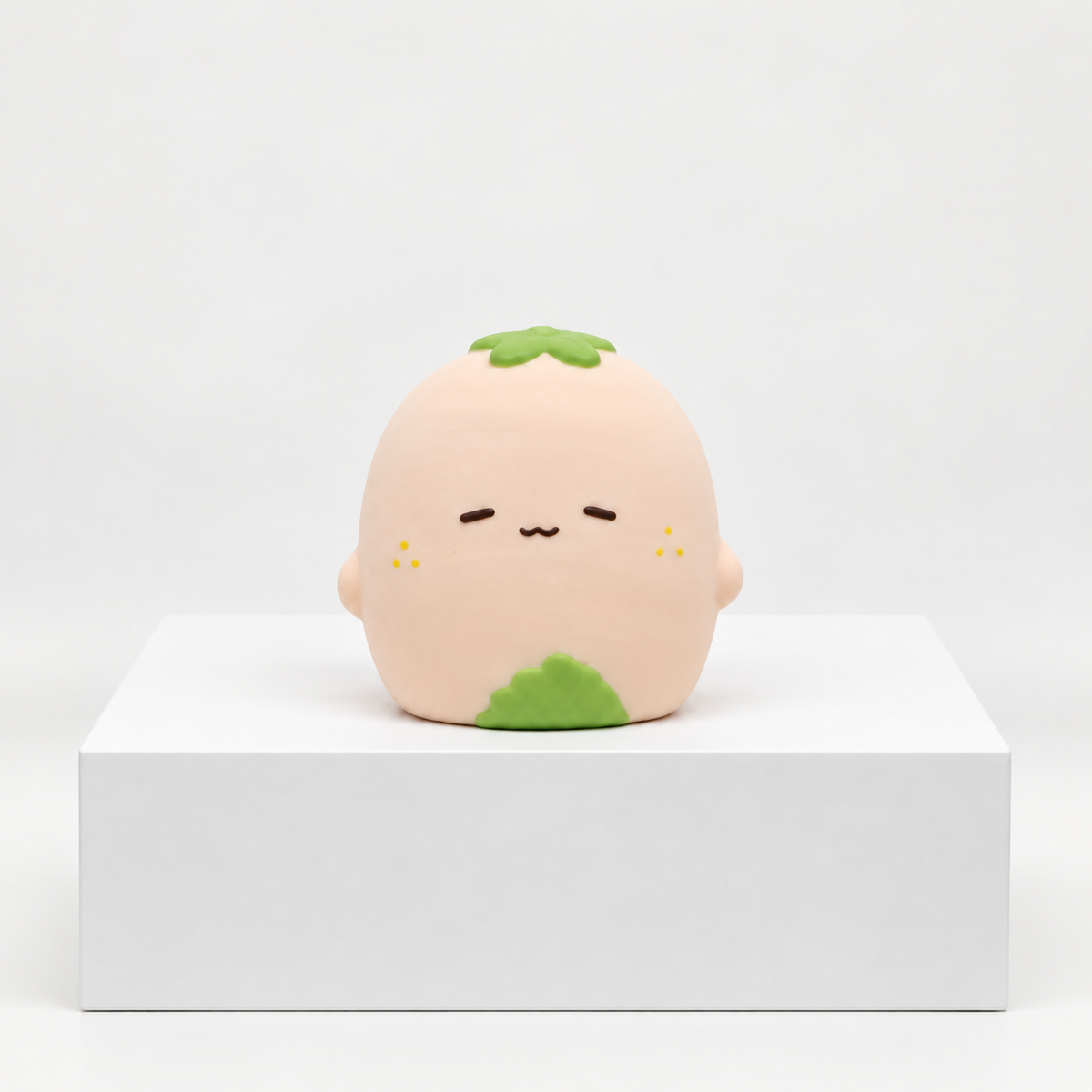 Pale pink Nunu strawberry character with green details, unboxed front view
