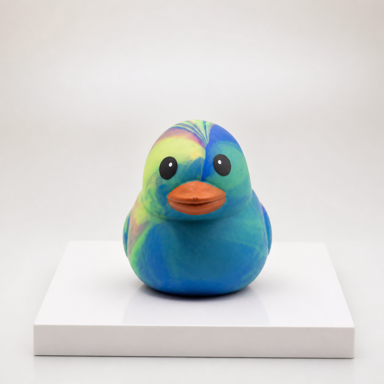 Sunny Days Entertainment jumbo tie-dye duck squishy with a unique multicolour pattern on a white pedestal