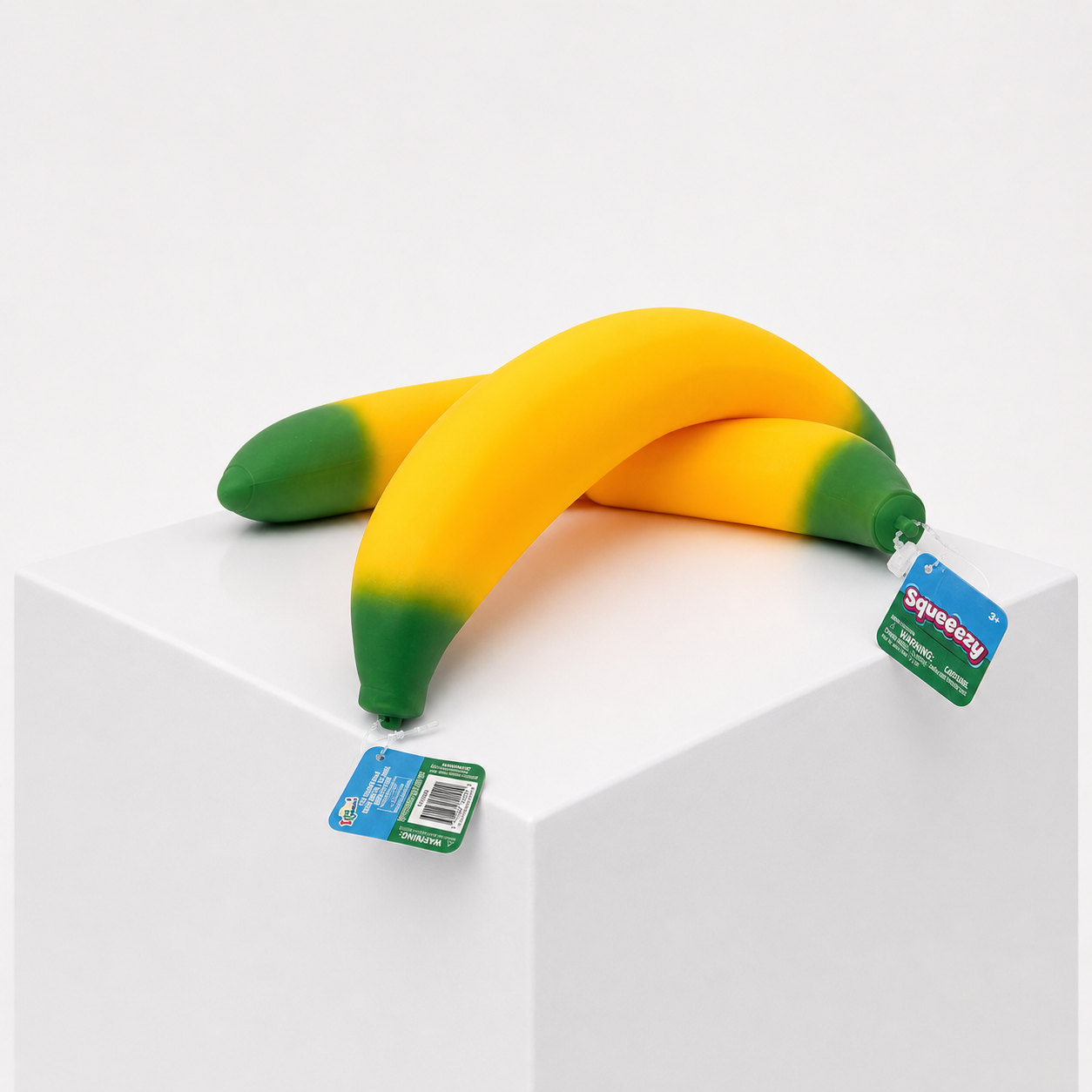 Sunny Days Entertainment Squeeezy Banana sensory fidget toy in orange and green product display.