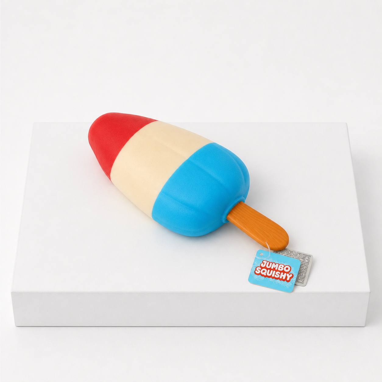 Red cream and blue Sunny Days Jumbo Squish Popsicle sensory toy on a white podium