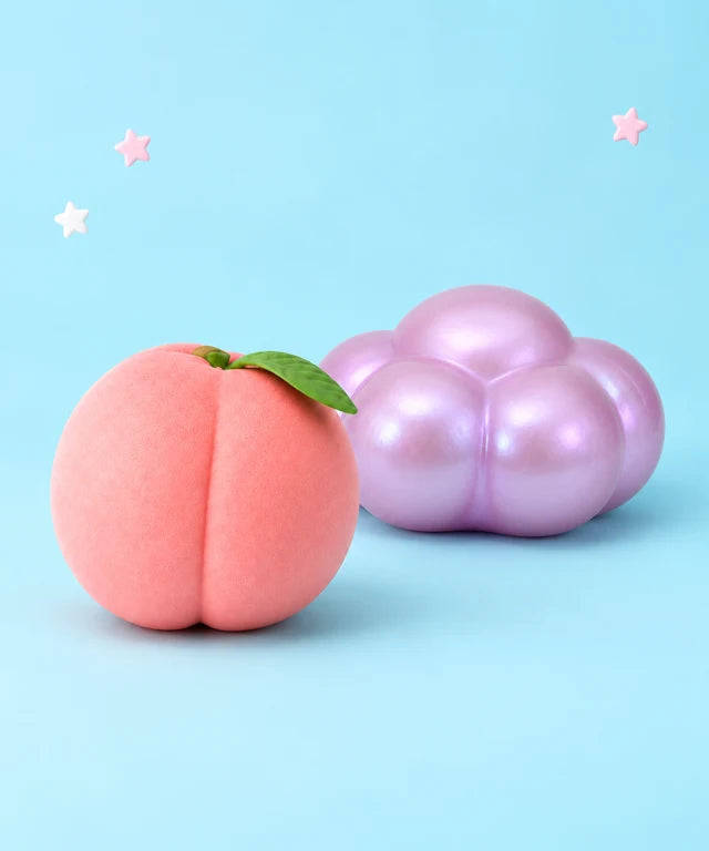 Pink peach and pearlescent lavender cloud squishy toys on a pastel blue background